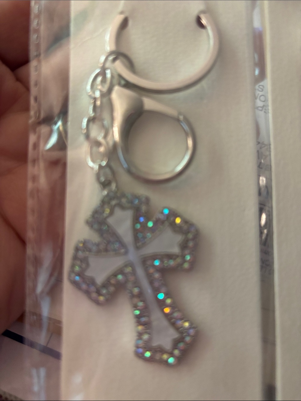 Silver -toned handbag charm featuring a crucifix cross